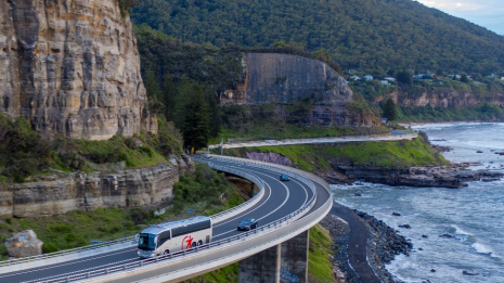 Image of Sydney charter bus along coastline