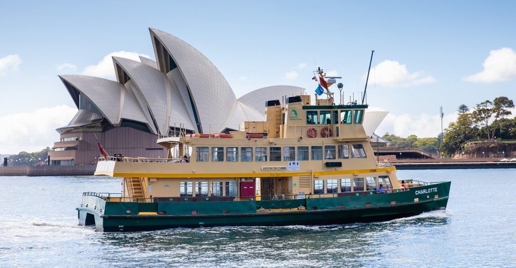 A First Fleet vessel docked at a wharf in Circular Quay with the Harbour Bridge in the background