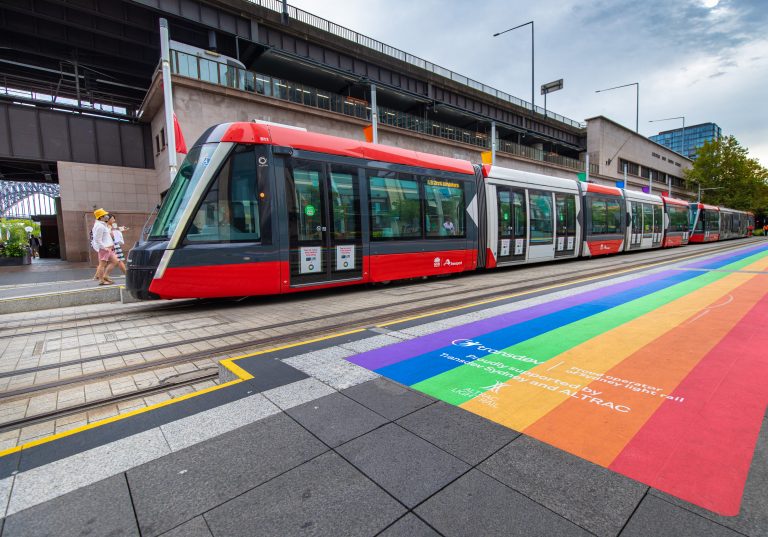 Light rail vehicle on Pride rainbow road